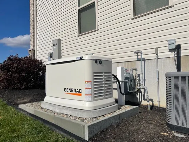 Generac generator installed behind a house